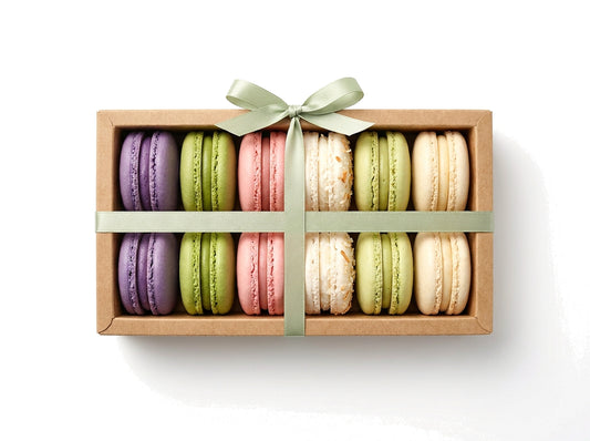 The Heritage Box — a dozen French macarons in a kraft box with a sage green ribbon bow