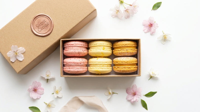The Seasonal Édition Bloom — spring macarons in Strawberry Bliss, Lemon Delight, and Tropical Mango