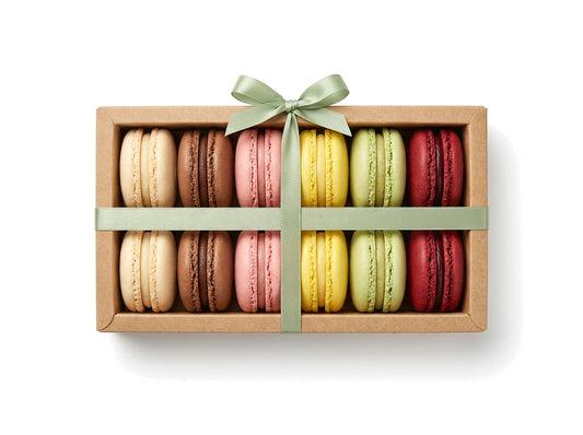 The Signature Collection — a dozen classic French macarons in a kraft box with a sage green ribbon bow